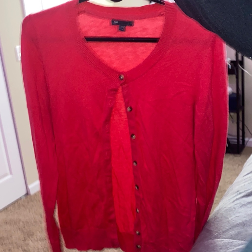 a pink knit cardigan sold by gap